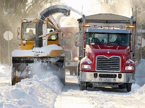 A snow removal crew works on 55th Ave. in the Lachine borough Monday December 16, 2013.