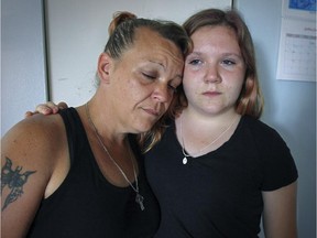 Vanessa Higgins rests her head on her daughter Jersey's shoulder at their Pointe-St-Charles homel on Monday, July 13, 2015.  Vanessa Higgins is the mother of Samantha Higgins, the 22-year-old woman whose body was found in Hinchinbrooke, southwest of Montreal, last month.