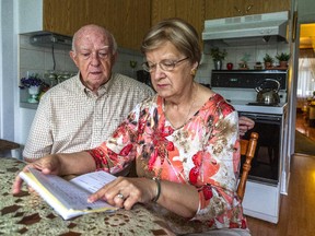 Noëlla Panneton, looking over her oncology records at home with her husband in Verdun, was told she wasn't eligible for a provincial refund for a certain cancer drug because of her age.
