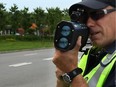 A police officer with a speed gun.
