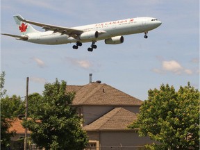 Airplane flies over houses on Marler Ave. in Dorval on their final approach to Pierre Elliot Trudeau Airport.