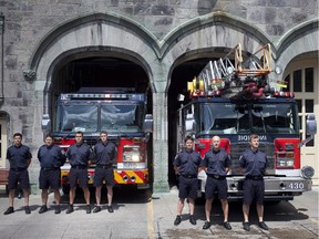 Firefighters from Station 30 in the Plateau Mont-Royal borough stand by their fire engines in Montreal on June 22, 2015,  during a minute of silence to honour former Montreal mayor Jean Doré.