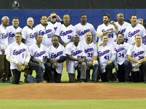 Members of the 1994 Expos pose for a photo during a ceremony to honour them before a preseason game between the Toronto Blue Jays and New York Mets at Montreal's Olympic Stadium on March 29, 2014.