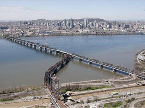 An aerial view of the Victoria bridge seen from the South Shore with the city in the background.