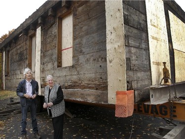 Judith Duncanson, right, president of Paul Holland Knowlton committee  and architectural consultant David Kininmonth, left, are standing in front the1815 Knowlton House, in Knowlton, a small town, one hour east of Montreal. It will be loaded onto a truck and moved to the Brome County Museum on Friday night at 6 p.m on October 17, 2014.The house has been stripped down to the original log cabin.They have taken off the roof so it won't bump into hydro lines while being moved. It will be reconstructed on a new foundation and turned into a museum.