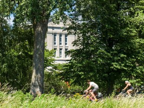 Saints-Anges Parish church peeks through the trees as cyclists and hikers take to the trails in sunny weather on Parc Promenade Pére-Marquete in Lachine.