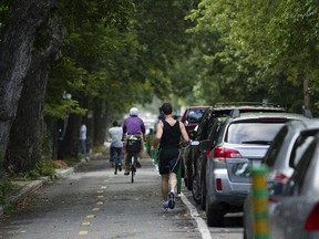 A man runs on a bicycle path.
