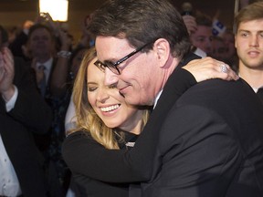 Newly elected PQ leader Pierre Karl Peladeau hugs Julie Snyder, moments after learning he won the leadership on the first ballot in Quebec city on Friday May 15, 2015. (Pierre Obendrauf / MONTREAL GAZETTE)
