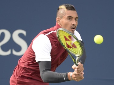 Nick Kyrgios, of Australia, returns to John Isner, of The United States, during round of sixteen play at the Rogers Cup tennis tournament on Thursday, August 13, 2015, in Montreal.