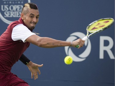 Nick Kyrgios, of Australia, returns to John Isner, of The United States, during round of sixteen play at the Rogers Cup tennis tournament on Thursday, August 13, 2015, in Montreal.