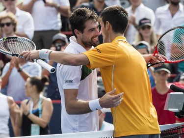 Novak Djokovic, left, of Serbia, and Jeremy Chardy, of France, embrace following their the semifinal match at the Rogers Cup tennis tournament on Saturday, August 15, 2015, in Montreal. Djokovic won 6-4, 6-4 to move on to the final.