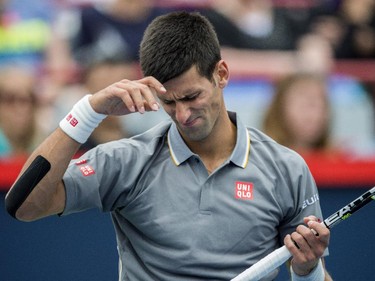 Novak Djokovic, of Serbia, grimaces following a volley with Jack Sock, of the United States, during round of sixteen play at the Rogers Cup tennis tournament Thursday August 13, 2015 in Montreal.