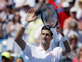 Novak Djokovic, of Serbia, waves to the crowd after defeating Stanislas Wawrinka, of Switzerland, in a quarterfinal match at the Western and Southern Open tennis tournament, Friday, Aug. 21, 2015, in Mason, Ohio.