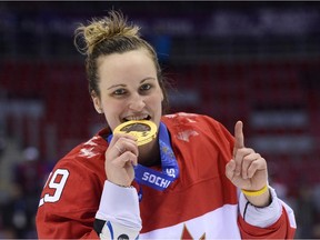 Team Canada hockey player Marie-Philip Poulin celebrates with her gold medal at the 2014 Sochi Winter Olympics at the Bolshoi Ice Dome on Feb. 20, 2014.