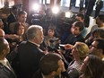 Quebec Premier Philippe Couillard speaks to reporters at the beginning of a Quebec Liberal government caucus meeting on Thursday, August 27, 2015, in St-Georges-de-Beauce.