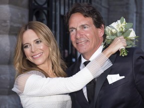 Parti Québécois Leader Pierre-Karl Péladeau and Julie Snyder hug after getting married, Saturday, August 15, 2015, in Quebec City.