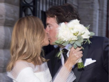 Parti Québécois Leader Pierre-Karl Peladeau and Julie Snyder kiss after getting married, Saturday, August 15, 2015, in Quebec City.