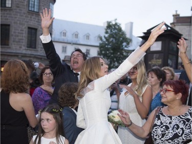 Parti Québécois Leader Pierre-Karl Peladeau and Julie Snyder wave to the crowd after getting married, Saturday, August 15, 2015, in Quebec City.