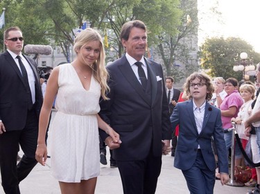 Parti Québécois Leader Pierre-Karl Peladeau accompanied by his son, Thomas, right, and daughter, Marie, arrive to marry to Julie Snyder, Saturday, August 15, 2015, in Quebec City.