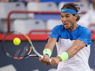 Rafael Nadal, of Spain, returns to Mikhail Youzhny, of Russia, during round of sixteen play at the Rogers Cup tennis tournament on Thursday, August 13, 2015, in Montreal.