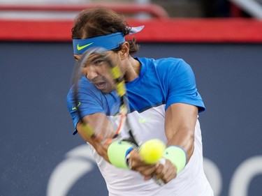 Rafael Nadal, of Spain, returns to Mikhail Youzhny, of Russia, during round of sixteen play at the Rogers Cup tennis tournament on Thursday, August 13, 2015, in Montreal.