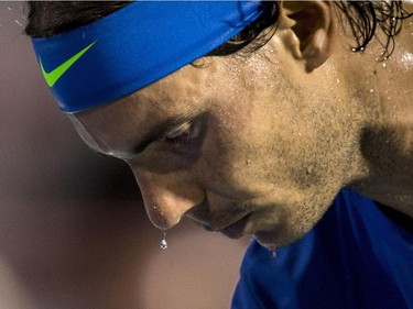 Sweat pours off the face of Rafael Nadal of Spain as he plays Kei Nishikori of Japan during quarter finals at the Rogers Cup tennis tournament Friday August 14, 2015 in Montreal.