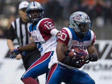 Montreal Alouettes' Tyrell Sutton (20) takes the handoff from quarterback Rakeem Cato during the first half of a CFL football game against the B.C. Lions in Vancouver, B.C., on Thursday August 20, 2015.