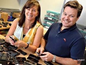 Staff at Recycell Inc. pour over used phones for re-use