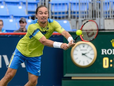Alexandr Dolgopolov of Ukraine hits a return against Grigor Dimitrov of Bulgaria during day two of the Rogers Cup at Uniprix Stadium on August 11, 2015 in Montreal, Quebec, Canada.