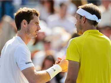 Andy Murray of Great Britain shakes hands with Gilles Muller of Luxembourg during day four of the Rogers Cup at Uniprix Stadium on August 13, 2015 in Montreal, Quebec, Canada.  Andy Murray defeated Gilles Muller 6-3, 6-2.
