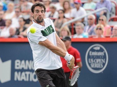 Jeremy Chardy of France hits a return against Novak Djokovic of Serbia during day six of the Rogers Cup at Uniprix Stadium on August 15, 2015, in Montreal, Quebec, Canada.  Novak Djokovic defeated Jeremy Chardy 6-4, 6-4.