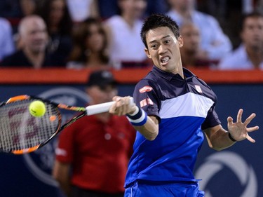 Kei Nishikori of Japan hits the ball against Andy Murray of Great Britain during day six of the Rogers Cup at Uniprix Stadium on August 15, 2015, in Montreal.