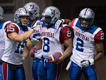 Montreal Alouettes' Samuel Giguere (15), Nik Lewis (8) and Fred Stamps (2) celebrate Lewis's touchdown against the B.C. Lions during the first half of a CFL football game in Vancouver, B.C., on Thursday August 20, 2015.