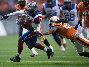 Montreal Alouettes' Stefan Logan, left, runs the ball past B.C. Lions' Ronnie Yell (25) during the first half of a CFL football game in Vancouver, B.C., on Thursday August 20, 2015.