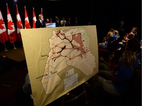 A map showing ISIL zones is displayed as Conservative Leader Stephen Harper delivers a speech during a campaign stop in Ottawa on Sunday, August 9, 2015. Harper announced that if re-elected his party would impose banned travel zones to combat terrorism.