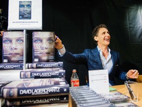 The author of the fourth novel in the Millennium series of crime novels, originally by Stieg Larsson, The Girl in the Spider's Web, Swedish journalist and best-selling author, David Lagercrantz, signs the books for first buyers during a midnight sell on August 27, 2015 at a local book store in Stockholm.