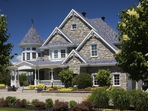 The house with its multi-gabled roof, turret, delicate trims and a wide porch is reminiscent of Victorian architecture. Photo by Perry Mastrovito