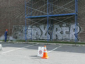 The photo of a tag being removed in Montreal North was published on Facebook Monday by political activist organization Hors-d'oeuvre. The graffiti in Henri-Bourassa park, which read "Freddy RIP" (sic) appeared sometime during the night of Aug. 9 to Aug. 10, 2015, according to the organization.