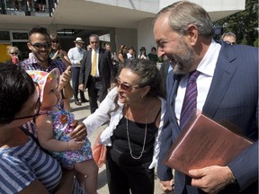 NDP Leader Thomas Mulcair and his wife, Catherine Pinhas, greet a young supporter during a campaign stop on Mount Royal on Tuesday.