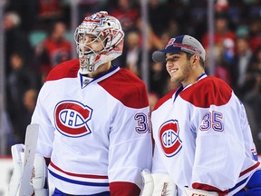 Canadiens goalies Carey Price (left) and Dustin Tokarski share a joke after the Habs defeated the Calgary Flames at Scotiabank Saddledome in Calgary on Oct. 28, 2014.