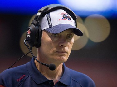 Montreal Alouettes head coach Tom Higgins watches from the sideline while playing the B.C. Lions during the first half of a CFL football game in Vancouver, B.C., on Thursday August 20, 2015.