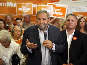 NDP Leader Tom Mulcair, speaks to his supporters from the campaign office of NDP Courtenay-Alberni candidate, Gord Johns,(left), during a campaign stop in Parksville, B.C., on Tuesday, Aug. 18, 2015. It's becoming apparent to those who've covered him in the past that Mulcair's "angry Tom" persona has been absent from this campaign - so far.