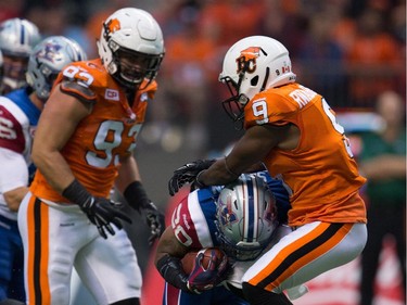 B.C. Lions' Chris Rwabukamba, right, stops Montreal Alouettes' Tyrell Sutton as he carries the ball during the first half of a CFL football game in Vancouver, B.C., on Thursday August 20, 2015.