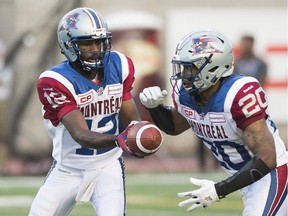 Alouettes QB Rakeem Cato hands off to Tyrell Sutton during CFL game against the Edmonton Eskimos in Montreal on Thursday, August 13, 2015.