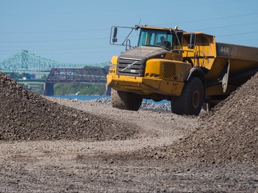 Heavy machinery constructs the jetty that will be used in the construction of the new Champlain bridge in Montreal on Friday, September 4, 2015.