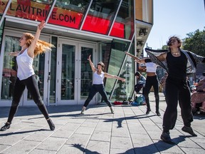 Girls dance on the corner of Ste-Catherine St. and St-Laurent Blvd. during the Ça Marche 2015 walk, the Farha Foundation's annual AIDS walk, in Montreal on Sunday, Sept.27, 2015.