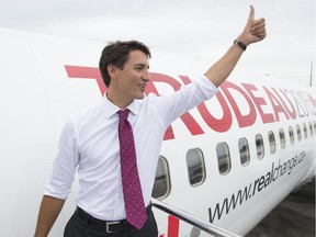 Liberal leader Justin Trudeau gives the thumbs up as he boards his campaign plane in Toronto, Wednesday, Sept, 9, 2015.