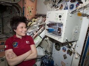 Astronaut Samantha Cristoforetti awaits a "cup" of espresso being brewed May 3, 2015, on a machine sent up to the International Space Station.