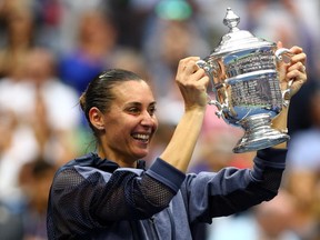 Flavia Pennetta of Italy celebrates with the winner's trophy after defeating Roberta Vinci of Italy during their Women's Singles Final match on Day 13 of the 2015 US Open at the USTA Billie Jean King National Tennis Center on Sept. 12, 2015, in the Flushing neighborhood of the Queens borough of New York City. Pennetta defeated Vinci 7-6, 6-2.