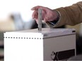 A man casts his vote for the 2011 federal election in Toronto in this May 2, 2011 photo.The first charge has been laid following Elections Canada's investigation of fraudulent robocalls during the 2011 federal election campaign.The lawyer for Michael Sona, a young campaign worker for the local Conservative candidate in Guelph, Ont., confirms he faces a single charge.THE CANADIAN PRESS/Chris Young ORG XMIT: cpt122